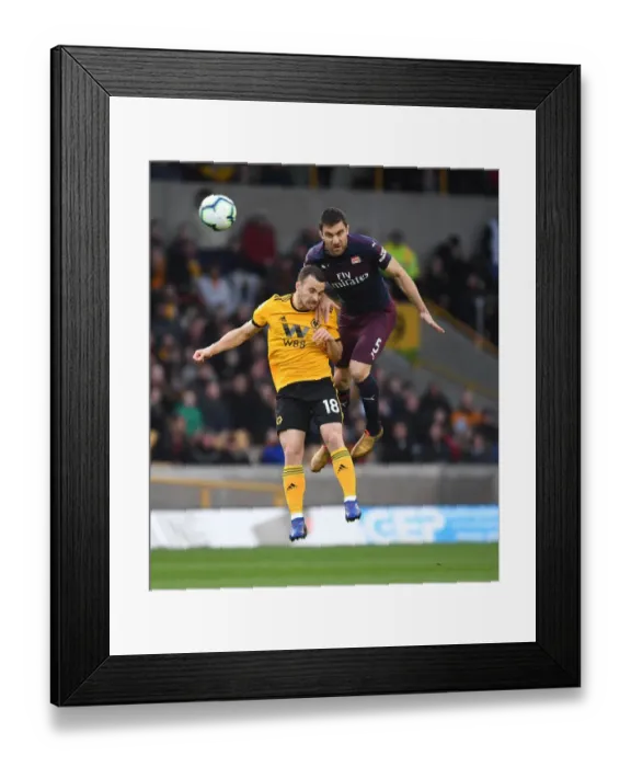 Framed Print : Sokratis vs. Diogo Jota: Intense Heading Battle at Wolverhampton Wanderers vs. Arsenal FC, Premier League 2018-19