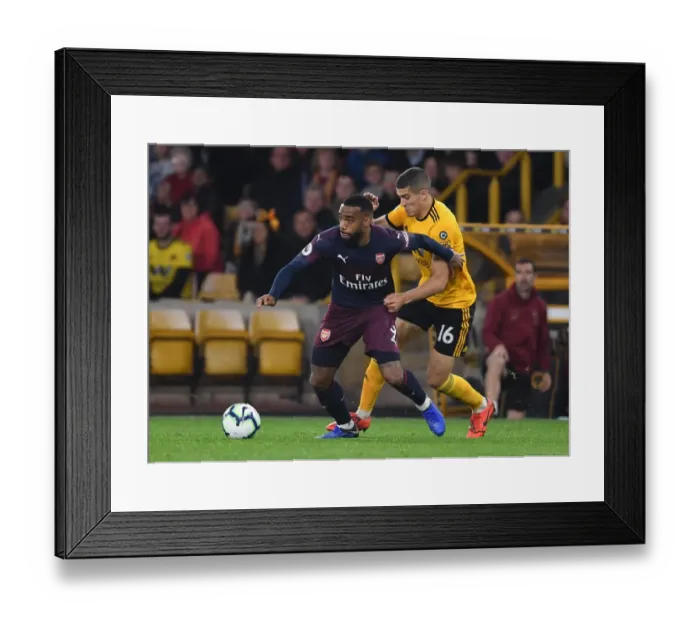 Framed Print : Arsenal's Lacazette Faces Off Against Wolverhampton's Coady in Premier League Clash Framed Print : Arsenal's Lacazette Faces Off Against Wolverhampton's Coady in Premier League Clash