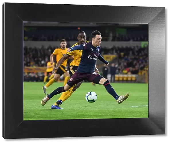 Mesut Ozil Under Pressure: Willy Boly Closes In during Wolverhampton Wanderers vs. Arsenal FC, Premier League 2018-19