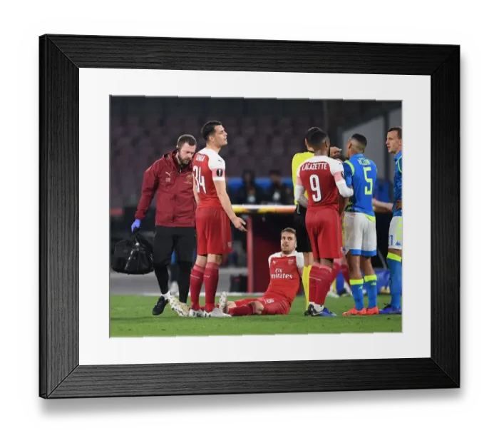 Framed Print : Arsenal's Aaron Ramsey Injured in Napoli's Europa League Quarterfinal Clash