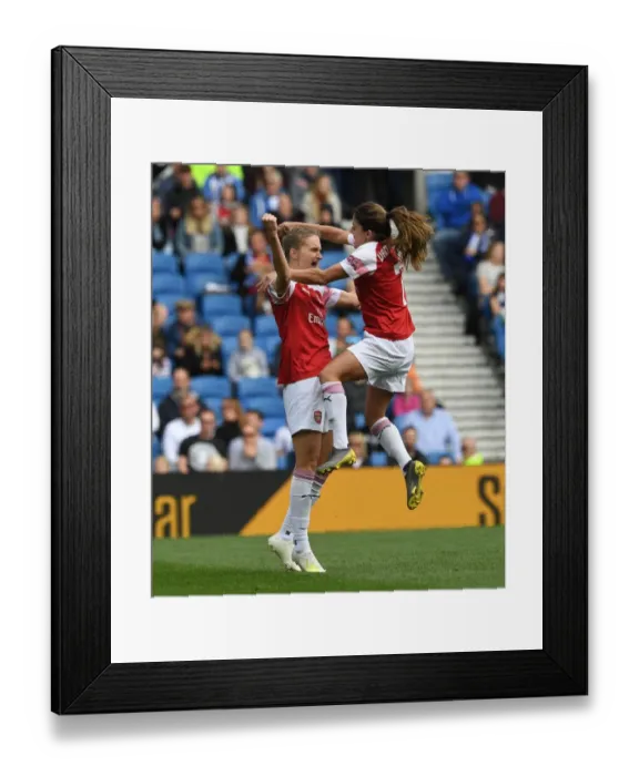 Framed Print : Miedema and van de Donk Celebrate Arsenal's Winning Goal vs. Brighton Women