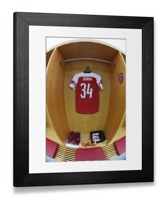 Framed Print : Arsenal's Empty Changing Room: Granit Xhaka's Absence in the UEFA Europa League Semi-Final First Leg vs Valencia