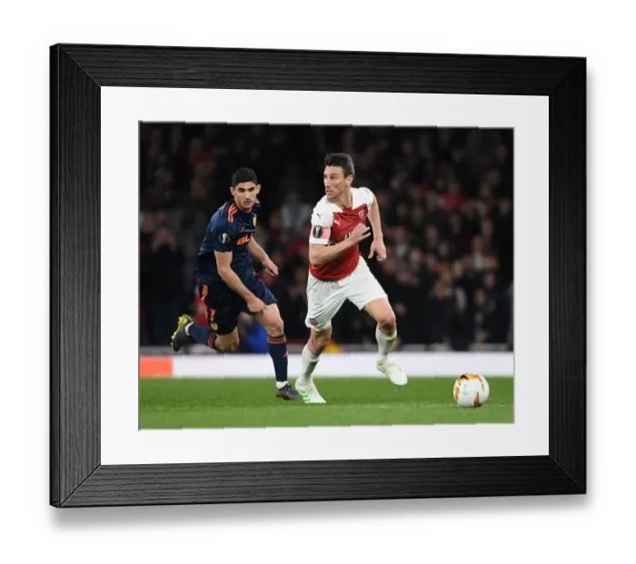 Framed Print : Arsenal vs Valencia: Koscielny Breaks Past Guedes in Europa League Semi-Final Showdown