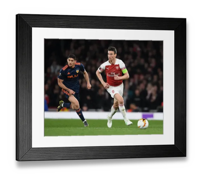 Framed Print : Arsenal's Laurent Koscielny Battles Past Valencia's Goncalo Guedes in UEFA Europa League Semi-Final Showdown Framed Print : Arsenal's Laurent Koscielny Battles Past Valencia's Goncalo Guedes in UEFA Europa League Semi-Final Showdown