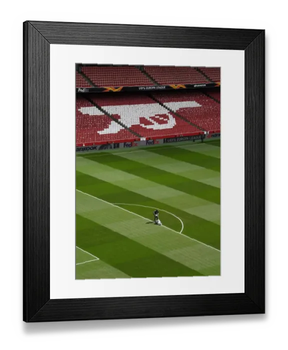 Framed Print : Arsenal: Preparing for Battle - Arsenal Groundsmen Set the Stage for Europa League Semi-Final vs Valencia