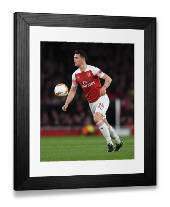 Framed Print : Granit Xhaka in Action: Arsenal's Europa League Battle against Valencia Framed Print : Granit Xhaka in Action: Arsenal's Europa League Battle against Valencia