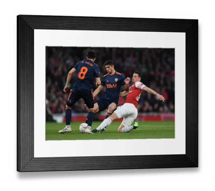 Framed Print : Xhaka vs Guedes: A Midfield Showdown in Arsenal's Europa League Battle with Valencia Framed Print : Xhaka vs Guedes: A Midfield Showdown in Arsenal's Europa League Battle with Valencia