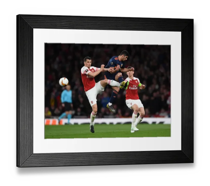 Framed Print : Xhaka vs. Guedes: A Midfield Showdown in the Arsenal vs. Valencia UEFA Europa League Semi-Final