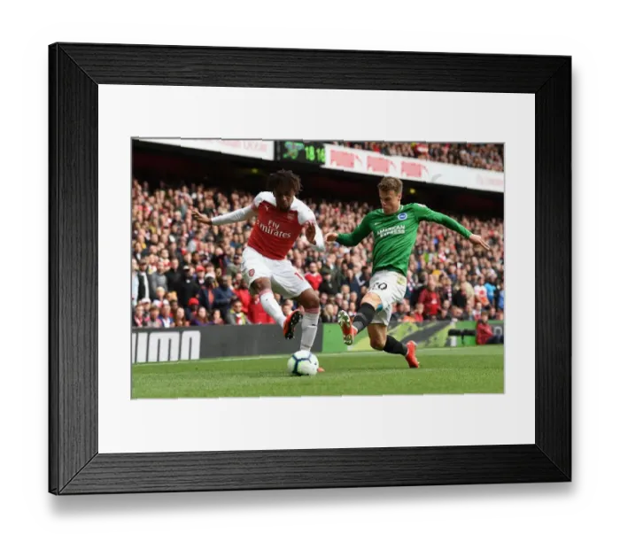 Framed Print : Arsenal's Alex Iwobi Faces Off Against Brighton's Solly March in Intense Premier League Clash Framed Print : Arsenal's Alex Iwobi Faces Off Against Brighton's Solly March in Intense Premier League Clash