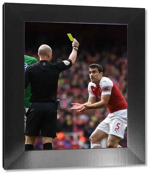 Sokratis Shown Yellow Card by Referee Taylor in Arsenal vs. Brighton Match