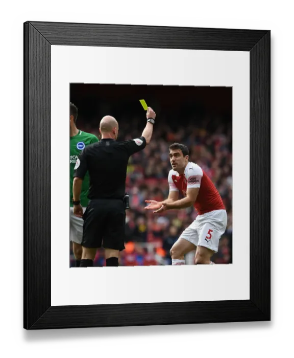 Framed Print : Sokratis Shown Yellow Card by Referee Taylor in Arsenal vs. Brighton Match