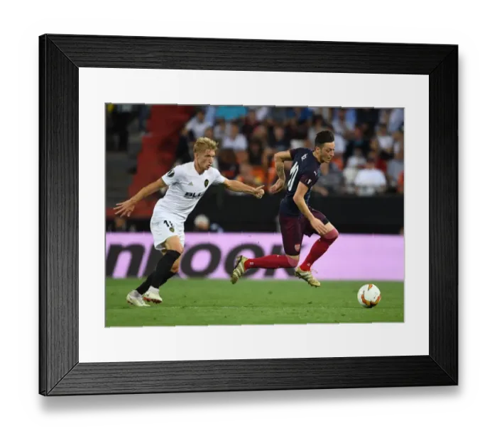 Framed Print : Mesut Ozil vs. Daniel Wass: A Europa League Semi-Final Battle at Valencia