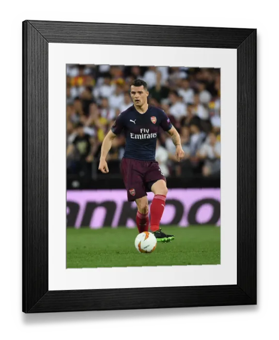 Framed Print : Granit Xhaka in Action: Arsenal's Semi-Final Battle at Valencia's Estadio Mestalla Framed Print : Granit Xhaka in Action: Arsenal's Semi-Final Battle at Valencia's Estadio Mestalla