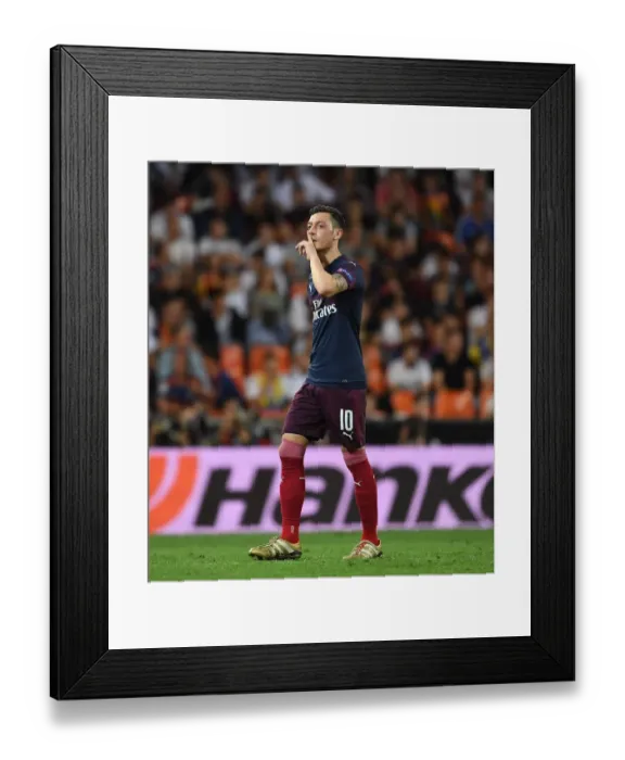 Framed Print : Mesut Ozil Gestures to Valencia Fans After Arsenal's Europa League Semi-Final Exit Framed Print : Mesut Ozil Gestures to Valencia Fans After Arsenal's Europa League Semi-Final Exit