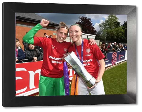 Arsenal Women Celebrate Historic WSL Title Win with Captains Sari van Veenendaal and Louise Quinn Holding the Trophy