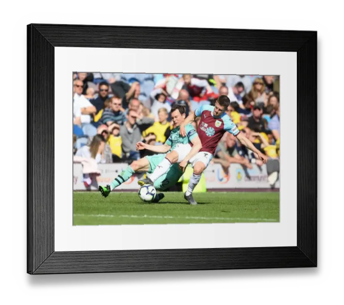 Framed Print : Intense Battle: Lichtsteiner vs. Gudmundsson - Premier League Clash between Burnley and Arsenal Framed Print : Intense Battle: Lichtsteiner vs. Gudmundsson - Premier League Clash between Burnley and Arsenal