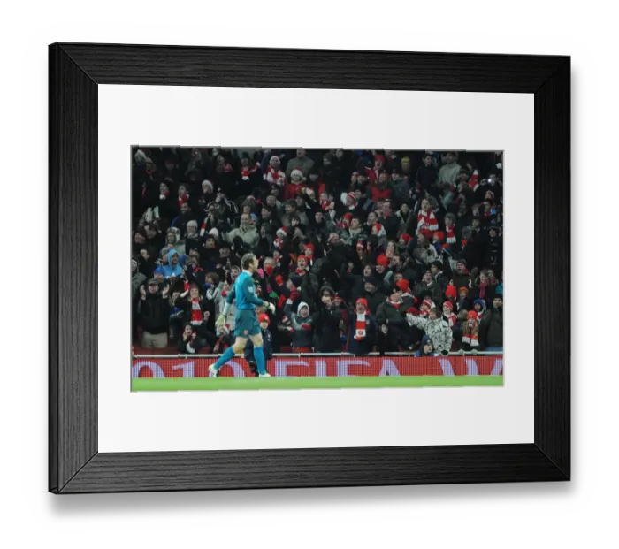 Framed Print : Arsenal fans celebrate after goalkeeper Manuel Almunia saves the Hull penalty taken by Geovanni