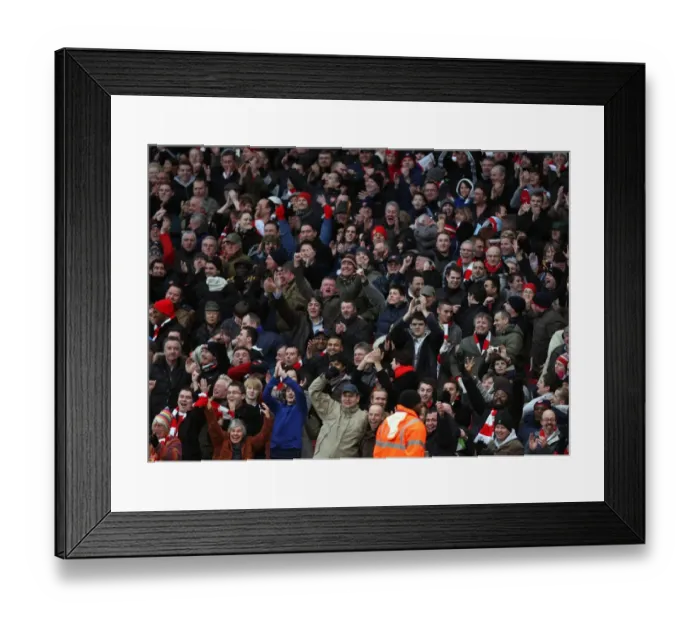 Framed Print : Arsenal fans celebrate Arsenals 3rd goal. Arsenal 3: 0 Aston Villa Framed Print : Arsenal fans celebrate Arsenals 3rd goal. Arsenal 3: 0 Aston Villa