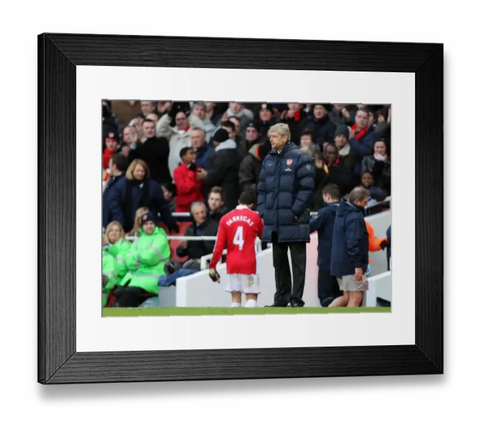Framed Print : Arsene Wenger the Arsenal Manager looks on as Cesc Fabregas (Arsenal) is lead down the tunnel for treatment on his injury. Arsenal 3: 0 Aston Villa. Barclays Premier League. Emirates Stadium, 27  /  12  /  09. Credit : Arsenal Football Club