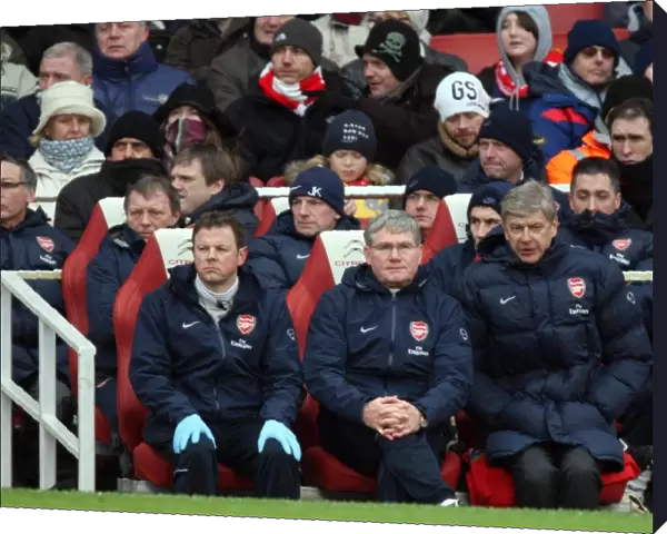 Arsene Wenger the Arsenal Manager sits on the bench with Pat Rice (Assistant Manager)