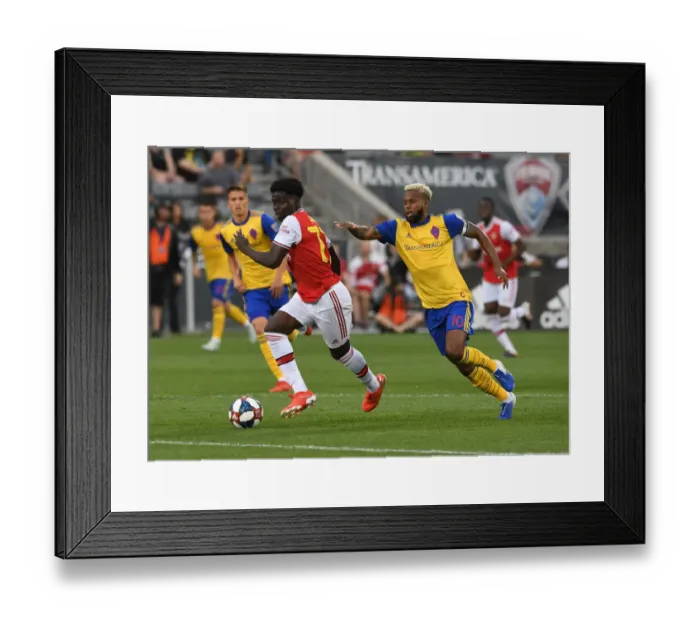 Framed Print : Arsenal's Bukayo Saka Goes Head-to-Head with Kellyn Acosta of Colorado Rapids in Pre-Season Clash Framed Print : Arsenal's Bukayo Saka Goes Head-to-Head with Kellyn Acosta of Colorado Rapids in Pre-Season Clash