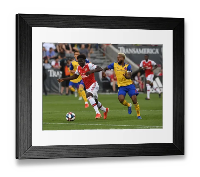 Framed Print : Arsenal's Bukayo Saka Faces Off Against Colorado Rapids Kellyn Acosta in 2019-20 Clash Framed Print : Arsenal's Bukayo Saka Faces Off Against Colorado Rapids Kellyn Acosta in 2019-20 Clash