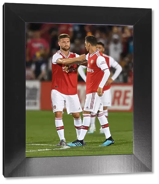 Arsenal's Mesut Ozil Receives Captain's Armband from Shkodran Mustafi during Colorado Rapids Match, 2019