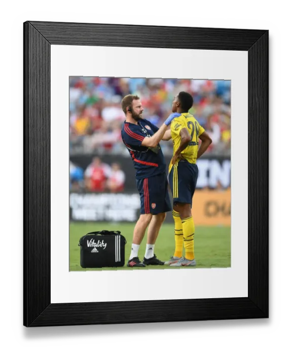 Framed Print : Arsenal: Joe Willock Receives Treatment from Physio Chris Morgan vs ACF Fiorentina, 2019 International Champions Cup, Charlotte