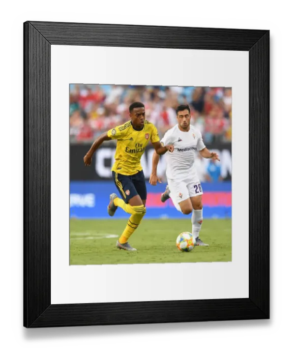Framed Print : Arsenal's Joe Willock Faces Off Against Fiorentina's Jaime Baez in International Champions Cup Clash Framed Print : Arsenal's Joe Willock Faces Off Against Fiorentina's Jaime Baez in International Champions Cup Clash