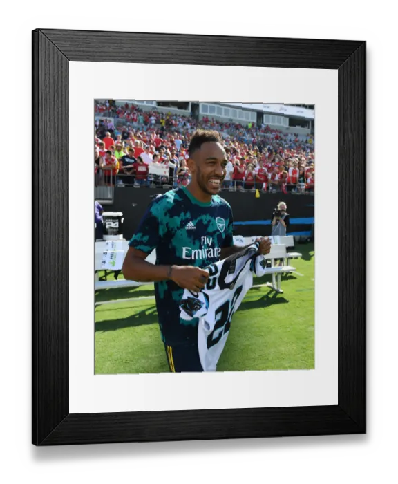 Framed Print : Arsenal's Aubameyang Receives Carolina Panthers Shirt from Christian McCaffrey Ahead of Arsenal v Fiorentina Match, 2019
