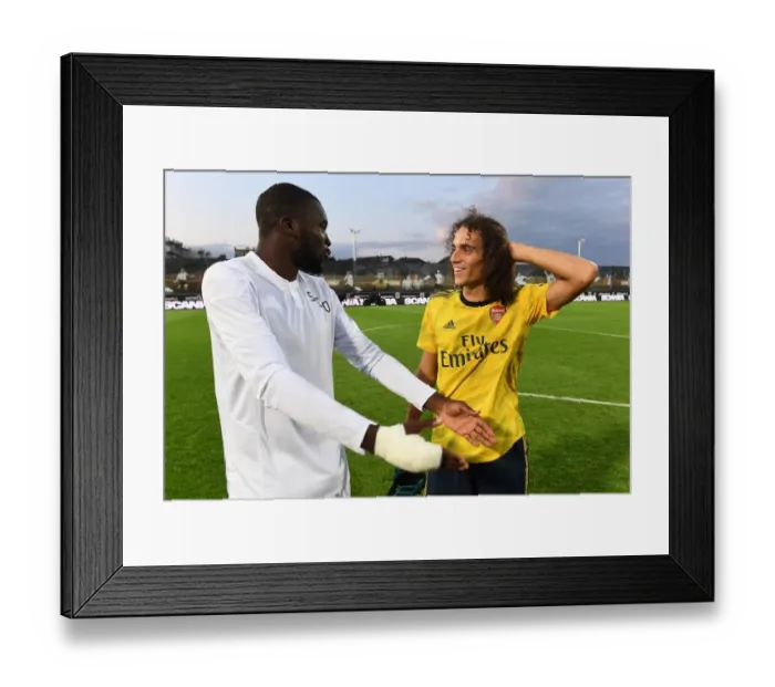 Framed Print : Guendouzi and Kanga Share a Moment After Angers vs. Arsenal Pre-Season Friendly