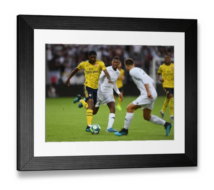 Framed Print : Arsenal's Ainsley Maitland-Niles Faces Off Against Jeff Reine-Adelaide in Angers Friendly