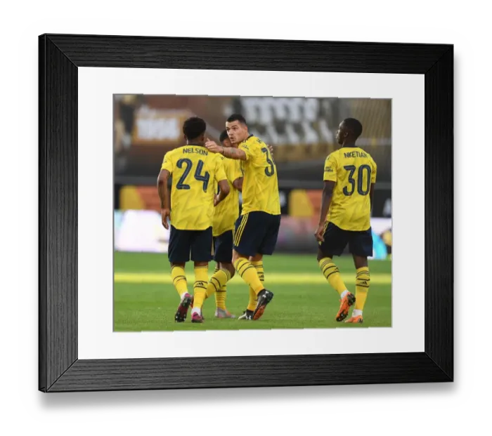 Framed Print : Xhaka and Nelson Celebrate Goal: Arsenal's Pre-Season Victory in Angers