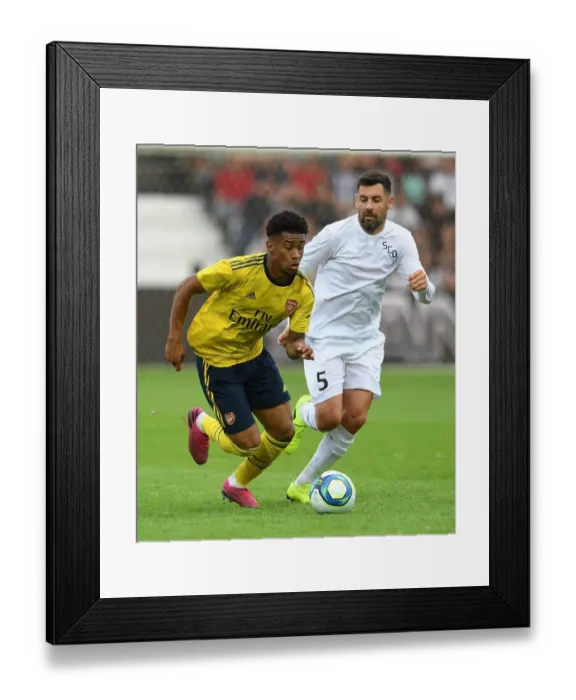Framed Print : Arsenal's Reiss Nelson Faces Off Against Angers Thomas Mangani in 2019 Pre-Season Friendly Framed Print : Arsenal's Reiss Nelson Faces Off Against Angers Thomas Mangani in 2019 Pre-Season Friendly