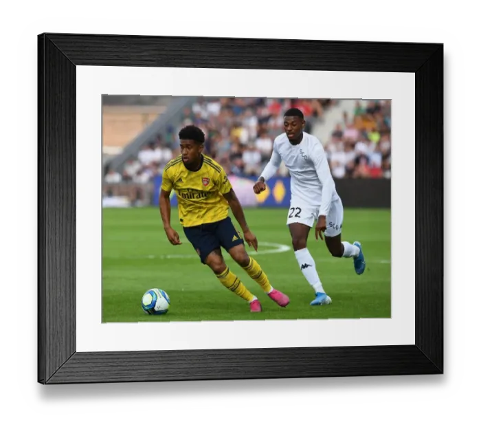 Framed Print : Angers vs Arsenal: Reiss Nelson Faces Off Against Jeff Reine-Adelaide in Pre-Season Friendly