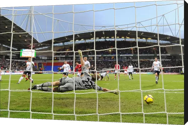 Cesc Fabregas shoots past Bolton goalkeeper Jussi Jskelainen to score the 1st Arsenal goal
