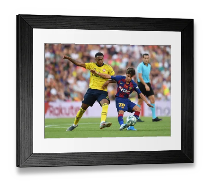 Framed Print : Clash at the Camp: Arsenal's Joe Willock Tackles Riqui Puig in FC Barcelona vs Arsenal Pre-Season Friendly