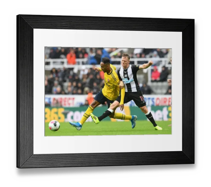 Framed Print : Clash of the Premier League Stars: Aubameyang vs. Ritchie - Arsenal's Star Forward Meets Newcastle's Midfield Maestro