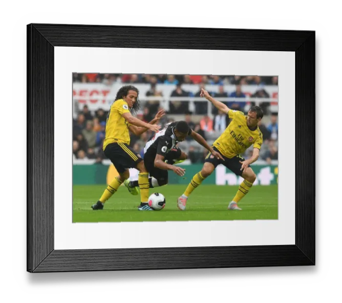 Framed Print : Clash at St. James Park: Arsenal's Guendouzi and Monreal Face Off Against Newcastle's Hayden (Newcastle United vs Arsenal, 2019-20)