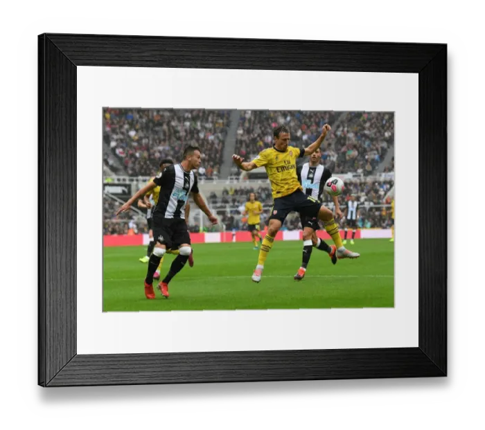 Framed Print : Nacho Monreal Faces Pressure from Javier Manquillo in Newcastle United vs Arsenal FC Premier League Clash Framed Print : Nacho Monreal Faces Pressure from Javier Manquillo in Newcastle United vs Arsenal FC Premier League Clash