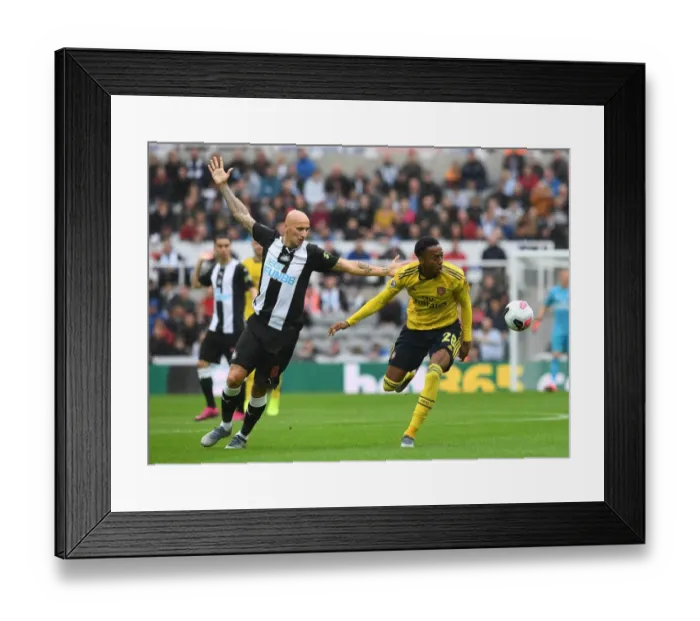 Framed Print : Joe Willock vs Jonjo Shelvey: Intense Battle in Newcastle United vs Arsenal FC Premier League Clash