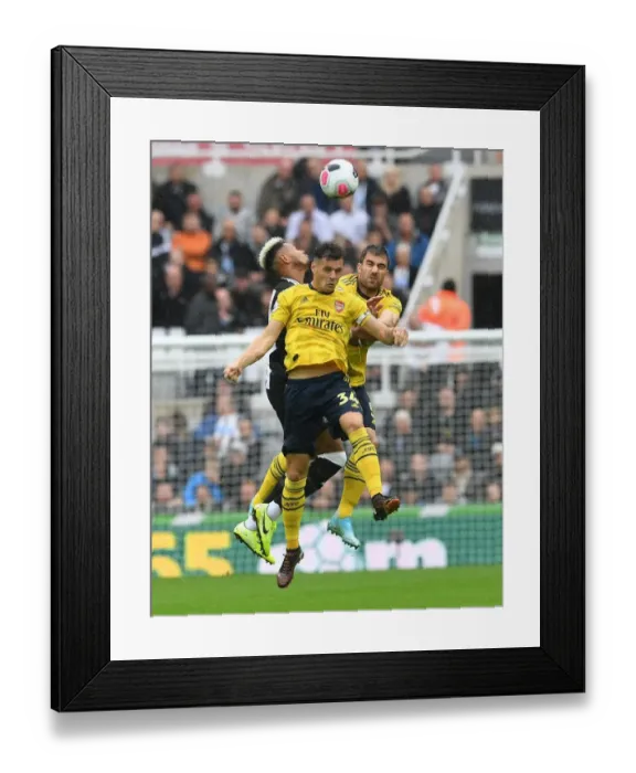 Framed Print : Clash at St. James Park: Xhaka and Sokratis Battle for Control in Newcastle United vs. Arsenal FC, Premier League 2019-20