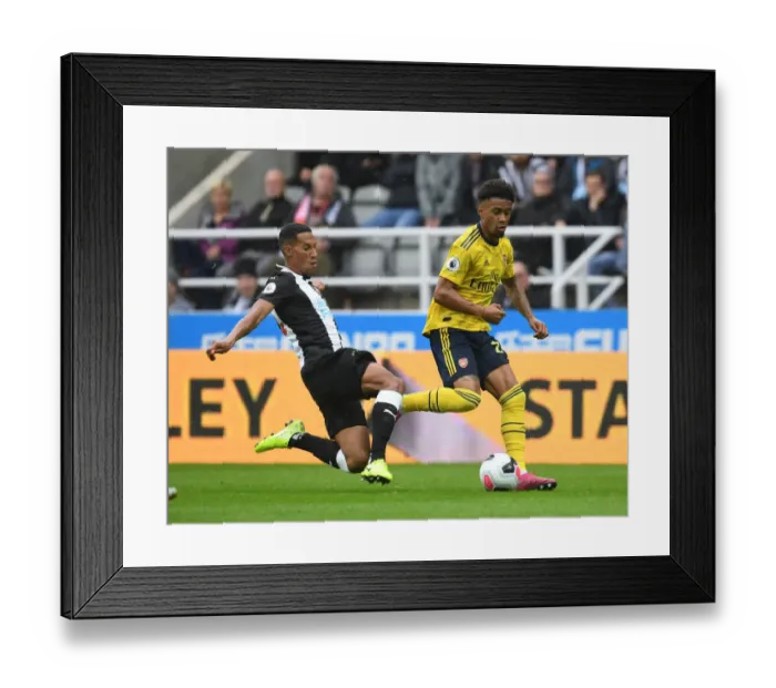 Framed Print : Reiss Nelson vs. Isaac Hayden: Battle at St. James Park - Newcastle United vs. Arsenal FC, Premier League 2019-2020