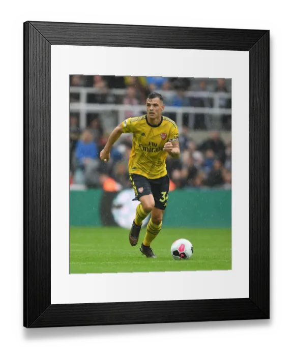 Framed Print : Granit Xhaka's Dominating Midfield Performance: Arsenal's Victory over Newcastle United