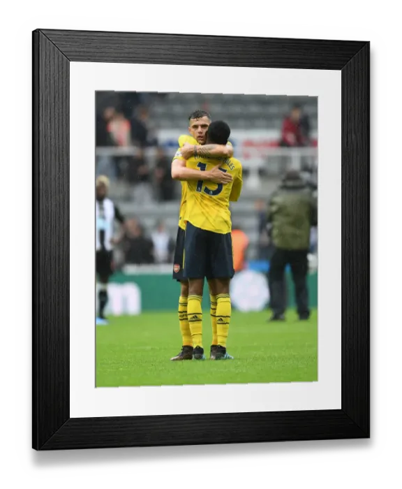 Framed Print : Arsenal's Emotional Victory: Xhaka and Maitland-Niles Embrace Post-Match at Newcastle United Framed Print : Arsenal's Emotional Victory: Xhaka and Maitland-Niles Embrace Post-Match at Newcastle United
