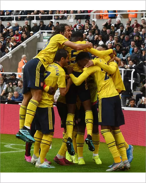 Aubameyang Strikes: Guendouzi and Mkhitaryan Celebrate Arsenal's Winning Goal vs. Newcastle United