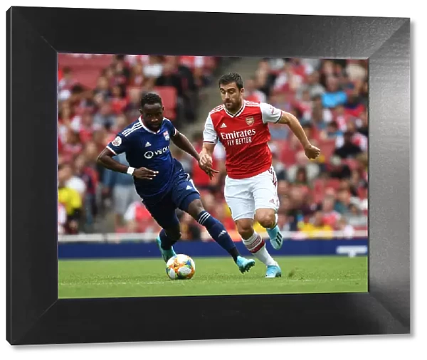 Arsenal vs. Olympique Lyonnais: Sokratis Breaks Past Moussa Dembele at the Emirates Cup