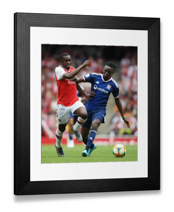 Framed Print : Arsenal's Eddie Nketiah Outmaneuvers Lyon's Bertrand Traore in Emirates Cup Clash Framed Print : Arsenal's Eddie Nketiah Outmaneuvers Lyon's Bertrand Traore in Emirates Cup Clash