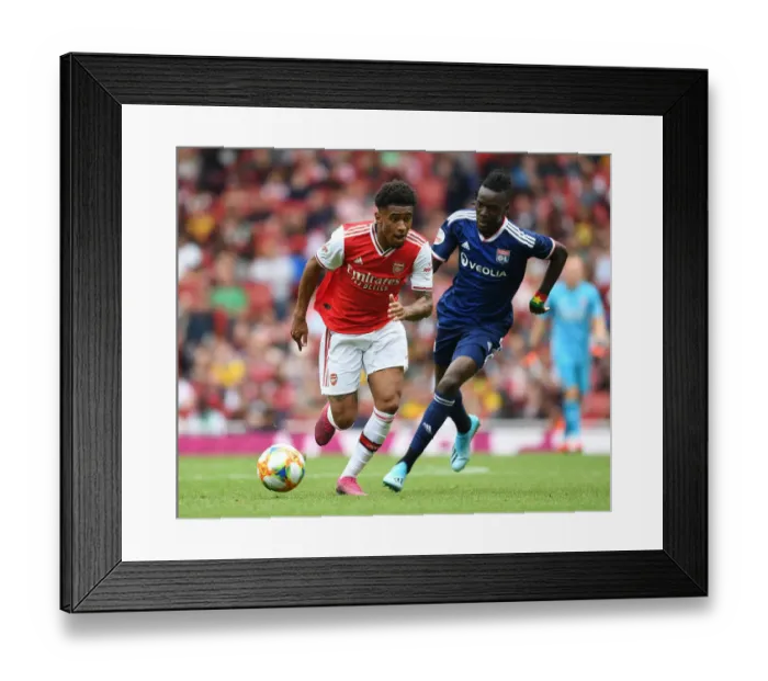 Framed Print : Arsenal's Reiss Nelson Outmaneuvers Olympique Lyonnais Bertrand Traore at Emirates Cup Framed Print : Arsenal's Reiss Nelson Outmaneuvers Olympique Lyonnais Bertrand Traore at Emirates Cup