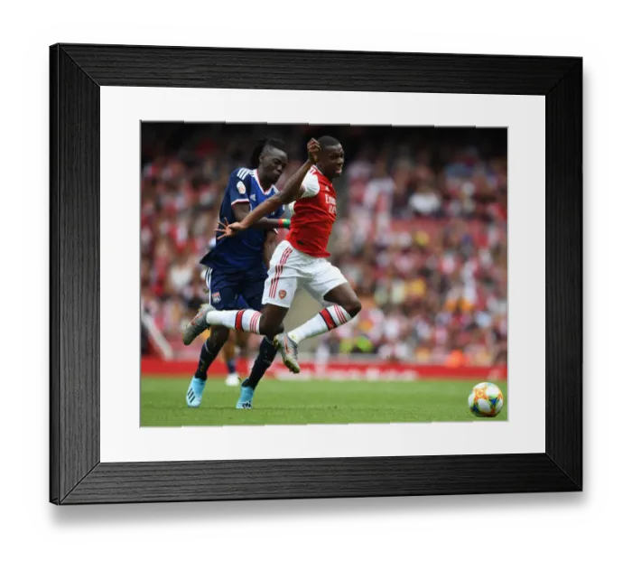 Framed Print : Arsenal's Eddie Nketiah Outmaneuvers Olympique Lyonnais Bertrand Traore during the 2019-20 Emirates Cup Match Framed Print : Arsenal's Eddie Nketiah Outmaneuvers Olympique Lyonnais Bertrand Traore during the 2019-20 Emirates Cup Match